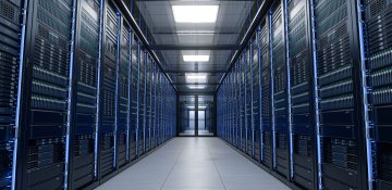 A hallway in a data center lined with server cabinets.
